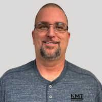 headshot of Travis Holzberger KMT Service Engineer